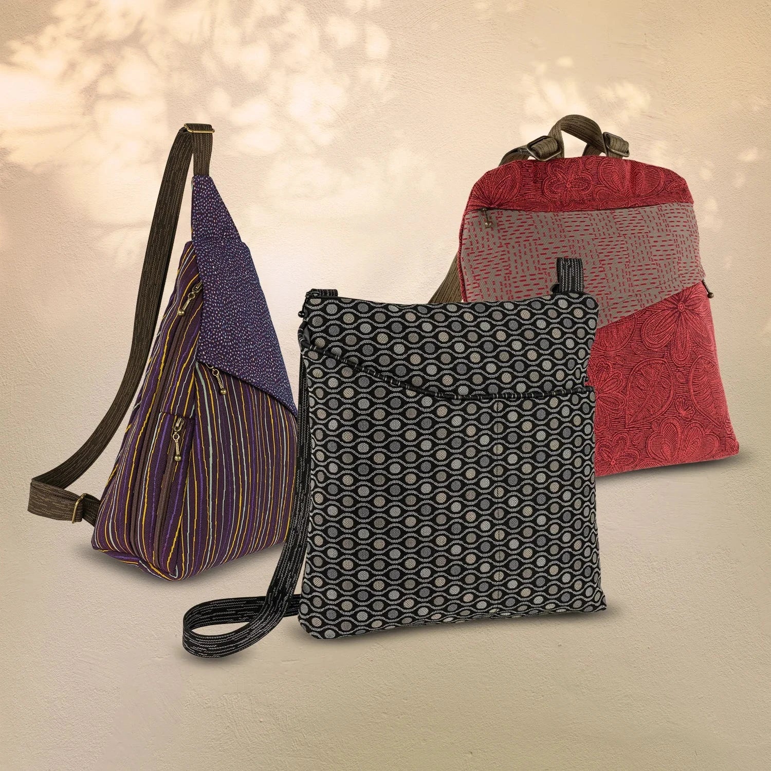 Bags in the picture include the GoGo Pack in the Mehndi Graphic fabric along with the large crossbody bag Café Sling in the Flora Cobalt fabric.