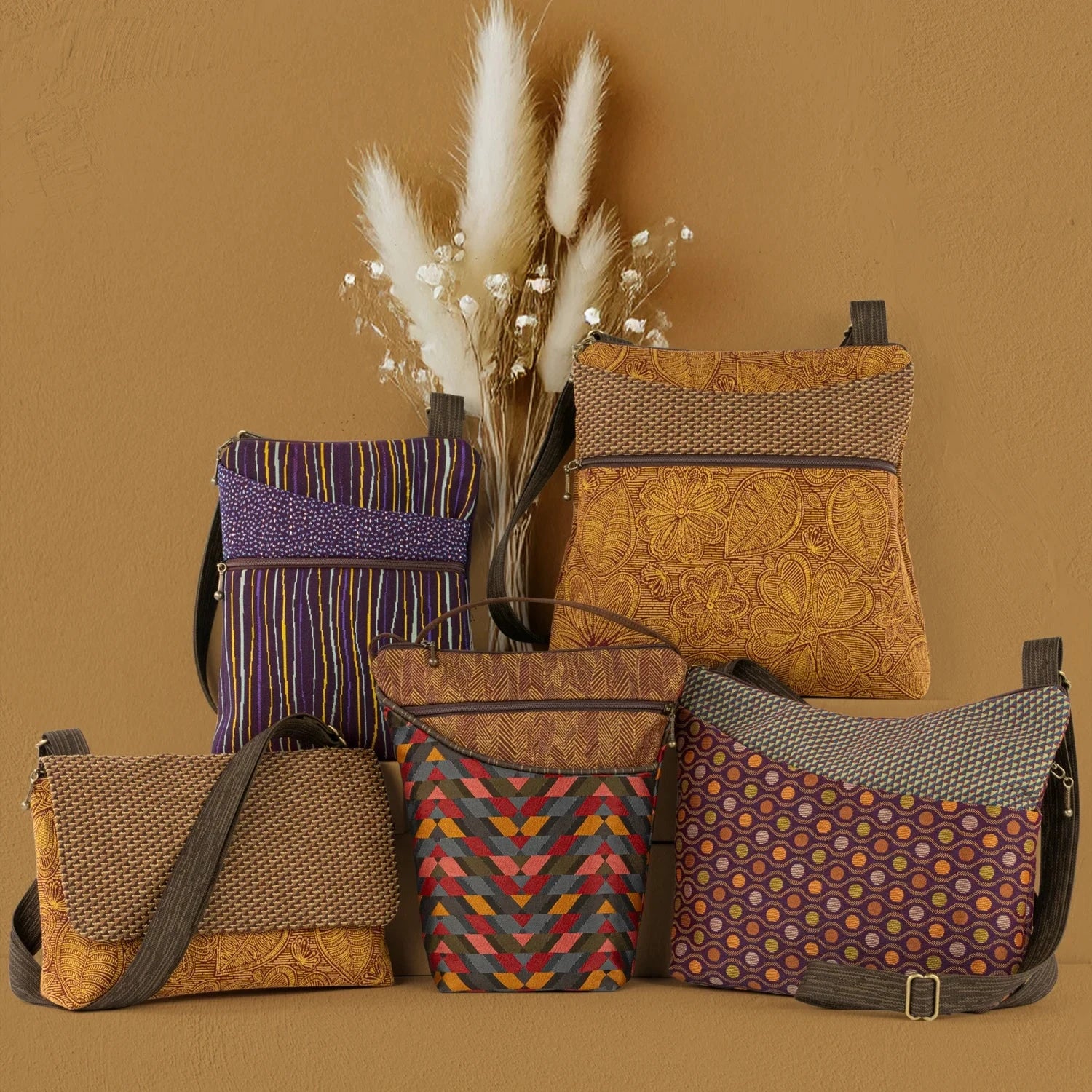 Mid-sized crossbody bag, Spree, shown in the Sierra Blue pattern with a tall corded crossbody bag, City Girl, shown in the Eclipse Warm pattern.